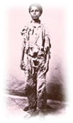 A vintage photo of a person standing posing for the camera

Description automatically generated